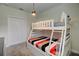 room features a bunk bed with colorful striped bedding and a Mickey Mouse lamp at 712 Whistling Straits Blvd, Davenport, FL 33896