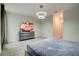 Bedroom featuring stylish light fixture, large TV, and contemporary furniture for relaxation and entertainment at 712 Whistling Straits Blvd, Davenport, FL 33896