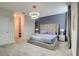Primary bedroom with a tufted headboard, modern lighting, and access to ensuite bathroom and closet at 712 Whistling Straits Blvd, Davenport, FL 33896