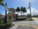 Community entrance sign for Champions Gate with decorative tower and well manicured greenery at 712 Whistling Straits Blvd, Davenport, FL 33896
