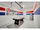 Finished garage with air hockey table and Avengers themed decor, perfect for recreation and entertainment at 712 Whistling Straits Blvd, Davenport, FL 33896