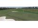 Image showcasing the manicured green on the golf course with sand traps near the green at 712 Whistling Straits Blvd, Davenport, FL 33896