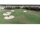 The photograph shows golfers putting on the green on this scenic, well-maintained golf course at 712 Whistling Straits Blvd, Davenport, FL 33896