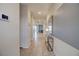 Inviting hallway with neutral tile flooring, modern decor, and ample natural light at 712 Whistling Straits Blvd, Davenport, FL 33896