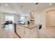 Beautiful kitchen island with quartz countertop, pendant lighting, and stainless steel appliances at 712 Whistling Straits Blvd, Davenport, FL 33896