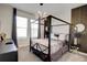 Modern bedroom with a four-poster bed, stylish wallpaper, and contemporary lighting fixtures at 712 Whistling Straits Blvd, Davenport, FL 33896