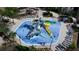Overhead shot of a vibrant community splash pad featuring slides, interactive water features, and shaded lounge areas at 712 Whistling Straits Blvd, Davenport, FL 33896