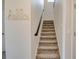 Carpeted stairway with a 'Hello' wall decoration leading to the upper level of the home at 712 Whistling Straits Blvd, Davenport, FL 33896