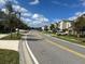 View down a sunny street lined with modern homes, sidewalks, and grassy areas at 712 Whistling Straits Blvd, Davenport, FL 33896