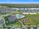 An aerial view showing community pool, residences, and a scenic pond in the distance at 11720 Language Way, Orlando, FL 32832