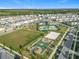 Community aerial view showcasing pool, playground, basketball and volleyball courts, offering diverse recreational options at 11720 Language Way, Orlando, FL 32832