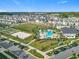 Community aerial view showcasing pool, playground, basketball and volleyball courts, offering diverse recreational options at 11720 Language Way, Orlando, FL 32832