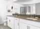 Bathroom featuring double sinks, modern fixtures, and a large mirror above the vanity at 11720 Language Way, Orlando, FL 32832