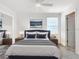 Modern bedroom with blue accents, white walls, and ample natural light at 11720 Language Way, Orlando, FL 32832