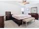 Well-lit bedroom with dark wood furniture, plush carpet and modern fan at 11720 Language Way, Orlando, FL 32832