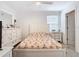 Bright bedroom with white furniture, a decorative bedspread, and a ceiling fan at 11720 Language Way, Orlando, FL 32832
