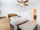 Bright bedroom featuring a ceiling fan, closet, and a bed with striped bedding at 11720 Language Way, Orlando, FL 32832
