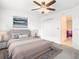 Calm bedroom featuring neutral tones, an ocean-themed artwork, and a plush bed at 11720 Language Way, Orlando, FL 32832