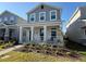 Charming two-story home featuring a welcoming front porch and well-manicured landscaping at 11720 Language Way, Orlando, FL 32832