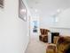 Bright hallway with plush seating, mini fridge and bedroom access, perfect for comfortable and convenient living at 11720 Language Way, Orlando, FL 32832