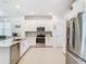 Modern kitchen featuring stainless steel appliances, granite countertops, and white cabinetry at 11720 Language Way, Orlando, FL 32832