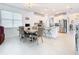 Eat-in kitchen featuring stainless appliances, island with seating, and natural light at 11720 Language Way, Orlando, FL 32832