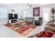 Spacious living room featuring a large television, comfortable sofas, and a patterned rug at 11720 Language Way, Orlando, FL 32832