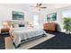 Stylish main bedroom with modern furniture, artwork, and plenty of natural light at 11720 Language Way, Orlando, FL 32832