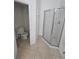 Bathroom featuring a glass shower, toilet, and tile flooring at 2846 Club Cortile Cir, Kissimmee, FL 34746