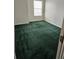 Bedroom with bright, clean, green carpet, natural light, and neutral walls at 2846 Club Cortile Cir, Kissimmee, FL 34746