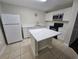 Modern kitchen with white cabinets, white countertops, an island, and stainless steel appliances at 2846 Club Cortile Cir, Kissimmee, FL 34746