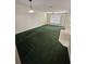 Bright living room with green carpet, a ceiling fan, and a light fixture overhead at 2846 Club Cortile Cir, Kissimmee, FL 34746