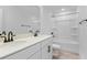 Modern bathroom features double sinks, white quartz counters, dark hardware and a shower-tub combo at 3709 Deer Ridge Dr, Mount Dora, FL 32757