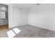 Clean bedroom featuring carpet floors, white walls, and a closet, and next to a bathroom at 3709 Deer Ridge Dr, Mount Dora, FL 32757