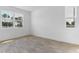 Bright, empty bedroom featuring tile floors and natural light from two windows at 3709 Deer Ridge Dr, Mount Dora, FL 32757