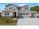 Charming two-story home with a well-manicured lawn and a three car garage at 3709 Deer Ridge Dr, Mount Dora, FL 32757