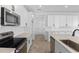Modern kitchen featuring an island, stainless steel appliances, and sleek white cabinetry at 3709 Deer Ridge Dr, Mount Dora, FL 32757