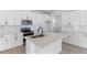 Modern kitchen featuring an island, stainless steel appliances, and sleek white cabinetry at 3709 Deer Ridge Dr, Mount Dora, FL 32757