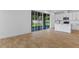 Open living area with tile floors leading to a modern kitchen and large sliding glass doors at 3709 Deer Ridge Dr, Mount Dora, FL 32757