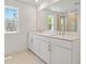 Bathroom features a double vanity, two mirrors, and a glass-enclosed shower at 3716 Deer Ridge Dr, Mount Dora, FL 32757