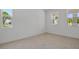 Bright bedroom with neutral walls, tiled floors, two windows providing ample natural light, and a spacious feel at 3716 Deer Ridge Dr, Mount Dora, FL 32757