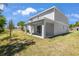 A two-story home's exterior features a covered patio, complemented by a well-maintained backyard at 3716 Deer Ridge Dr, Mount Dora, FL 32757