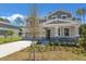 Charming two-story home featuring stone accents, manicured landscaping, and a well-maintained front yard on a sunny day at 3716 Deer Ridge Dr, Mount Dora, FL 32757