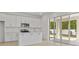 Open-concept kitchen featuring white cabinets, stainless steel appliances, and sliding glass doors to the outdoor patio at 3716 Deer Ridge Dr, Mount Dora, FL 32757