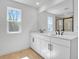 An elegant bathroom featuring double sinks with a tiled shower and contemporary fixtures at 3764 Deer Ridge Dr, Mount Dora, FL 32757