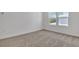 Bright bedroom featuring plush carpeting, natural light, and a comfortable layout at 3764 Deer Ridge Dr, Mount Dora, FL 32757