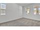 Bright bedroom with neutral carpet and three windows, creating a peaceful retreat bathed in natural light at 3764 Deer Ridge Dr, Mount Dora, FL 32757