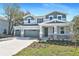 Charming two-story home boasts a three-car garage and inviting stone accents on a well-manicured front lawn at 3764 Deer Ridge Dr, Mount Dora, FL 32757