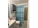 Full bathroom with vanity, cabinet, toilet, and bathtub with striped shower curtain at 824 San Pedro Ct, Kissimmee, FL 34758