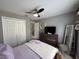 Bright bedroom with a ceiling fan, dresser, and a full-length mirror at 824 San Pedro Ct, Kissimmee, FL 34758